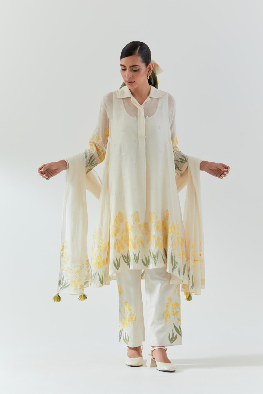 Off white cotton chanderi A-line short kurta set with yellow & green applique work at hem, highlighted with bead & sequins work.