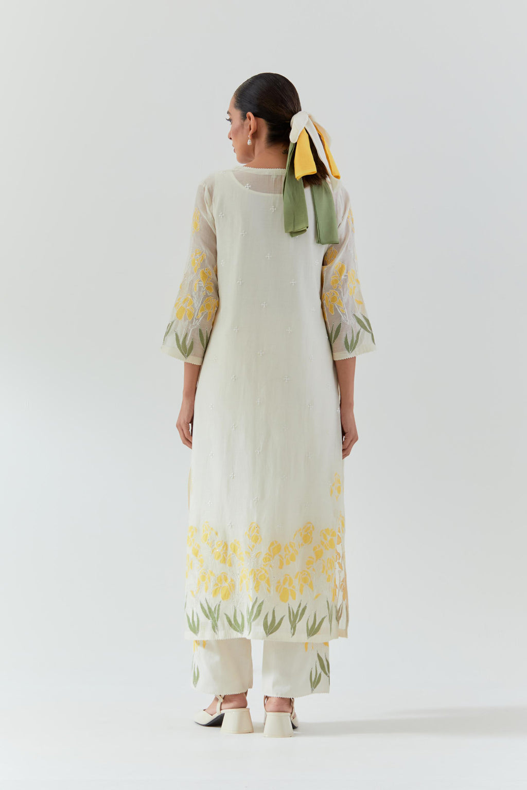 Off white cotton chanderi straight kurta set, decorated with yellow & green appliqué at the hem and sleeves.