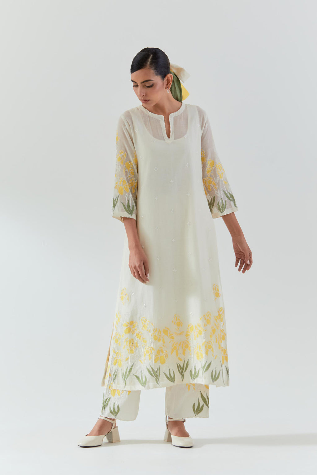 Off white cotton chanderi straight kurta set, decorated with yellow & green appliqué at the hem and sleeves.