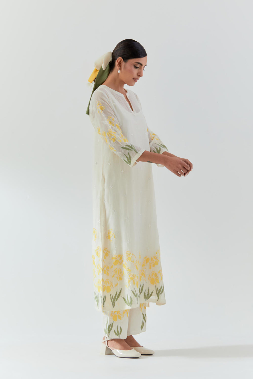 Off white cotton chanderi straight kurta set, decorated with yellow & green appliqué at the hem and sleeves.