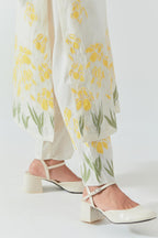 Off white cotton chanderi straight kurta set, decorated with yellow & green appliqué at the hem and sleeves.