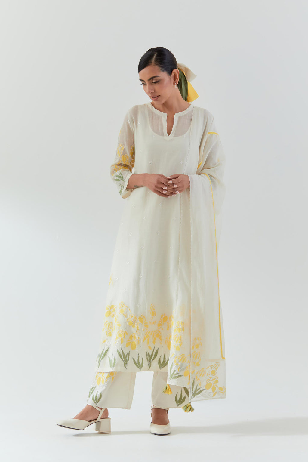 Off white cotton chanderi straight kurta set, decorated with yellow & green appliqué at the hem and sleeves.