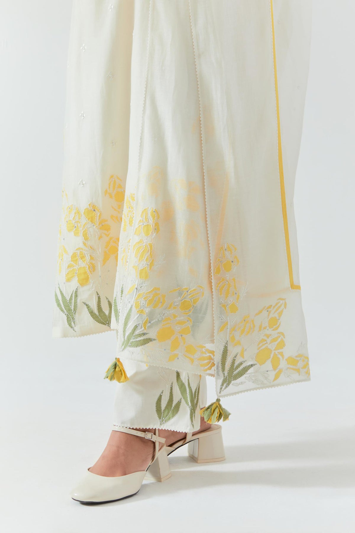 Off white cotton chanderi straight kurta set, decorated with yellow & green appliqué at the hem and sleeves.
