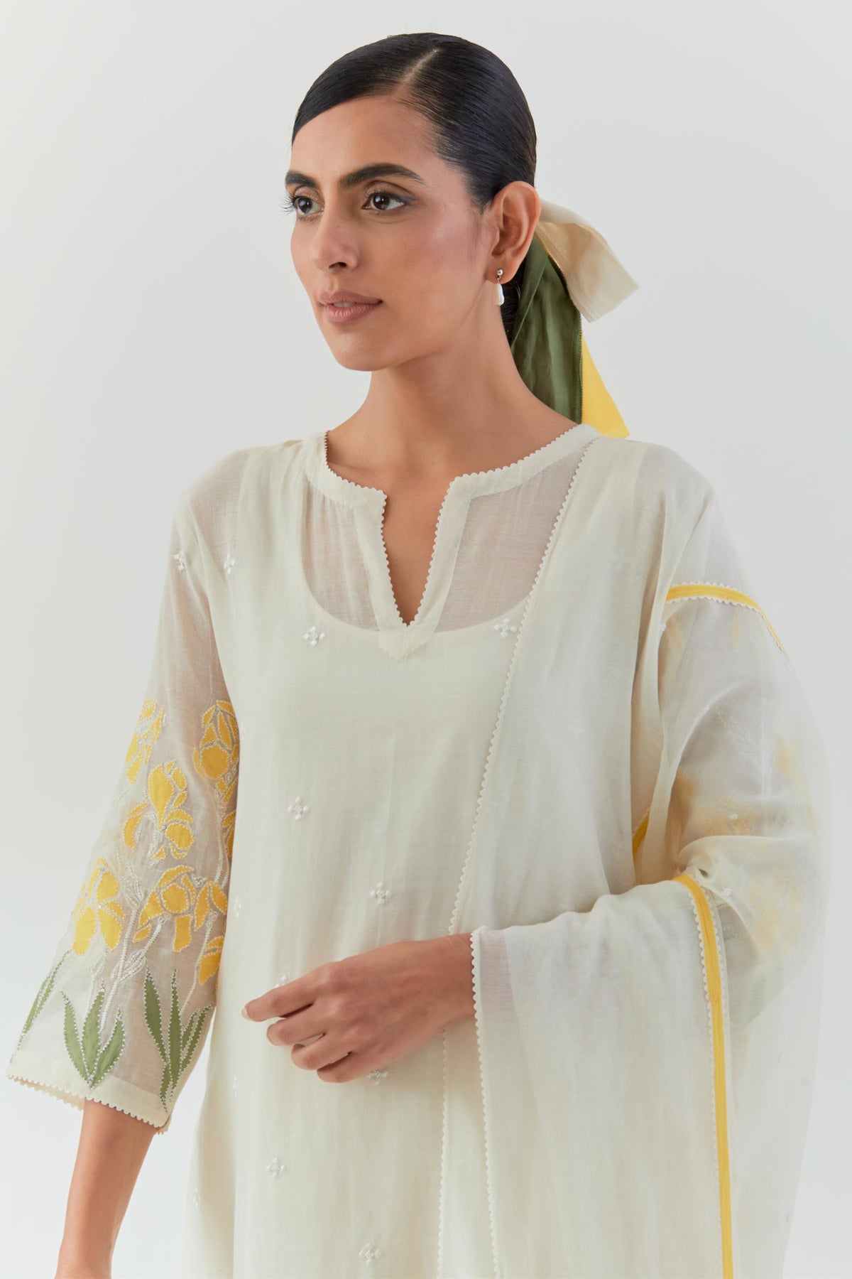 Off white cotton chanderi dupatta with yellow & green colored applique, highlighted with bead & sequins work.