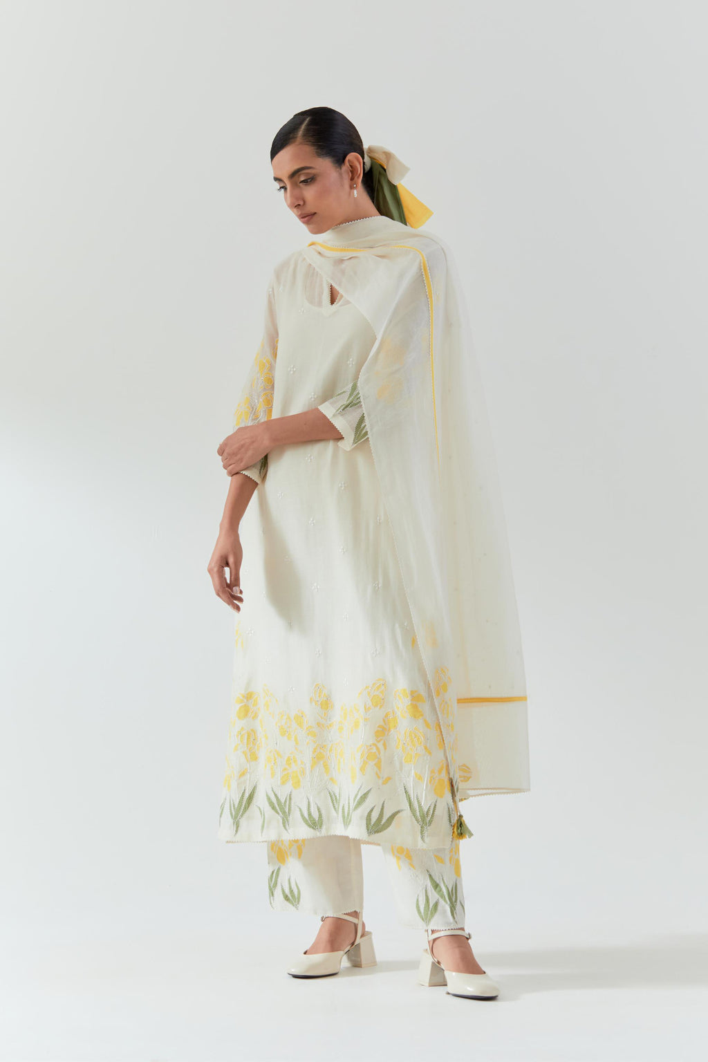 Off white cotton chanderi straight kurta set, decorated with yellow & green appliqué at the hem and sleeves.