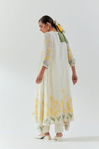 Off white cotton chanderi easy fit, asymmetric hem, paneled kurta set with yellow & green applique work at hem and sleeves.