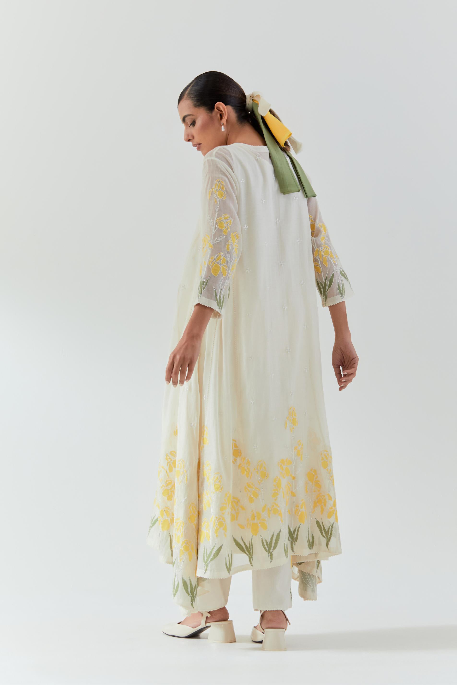 Off white cotton chanderi easy fit, asymmetric hem, paneled kurta set with yellow & green applique work at hem and sleeves.