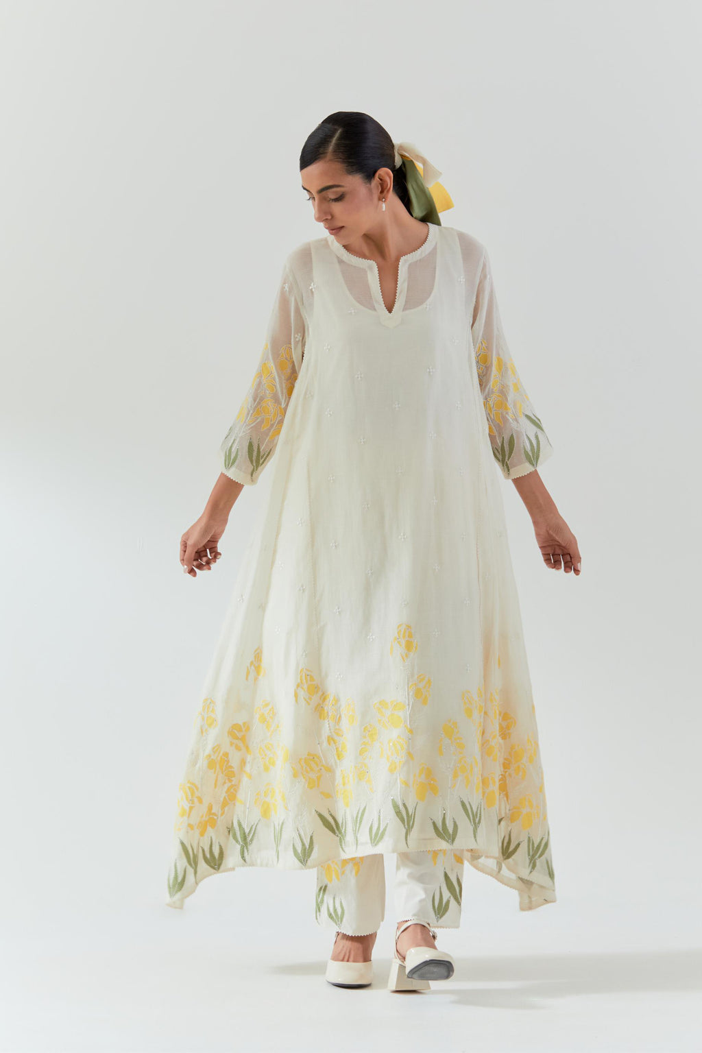 Off white cotton chanderi easy fit, asymmetric hem, paneled kurta set with yellow & green applique work at hem and sleeves.