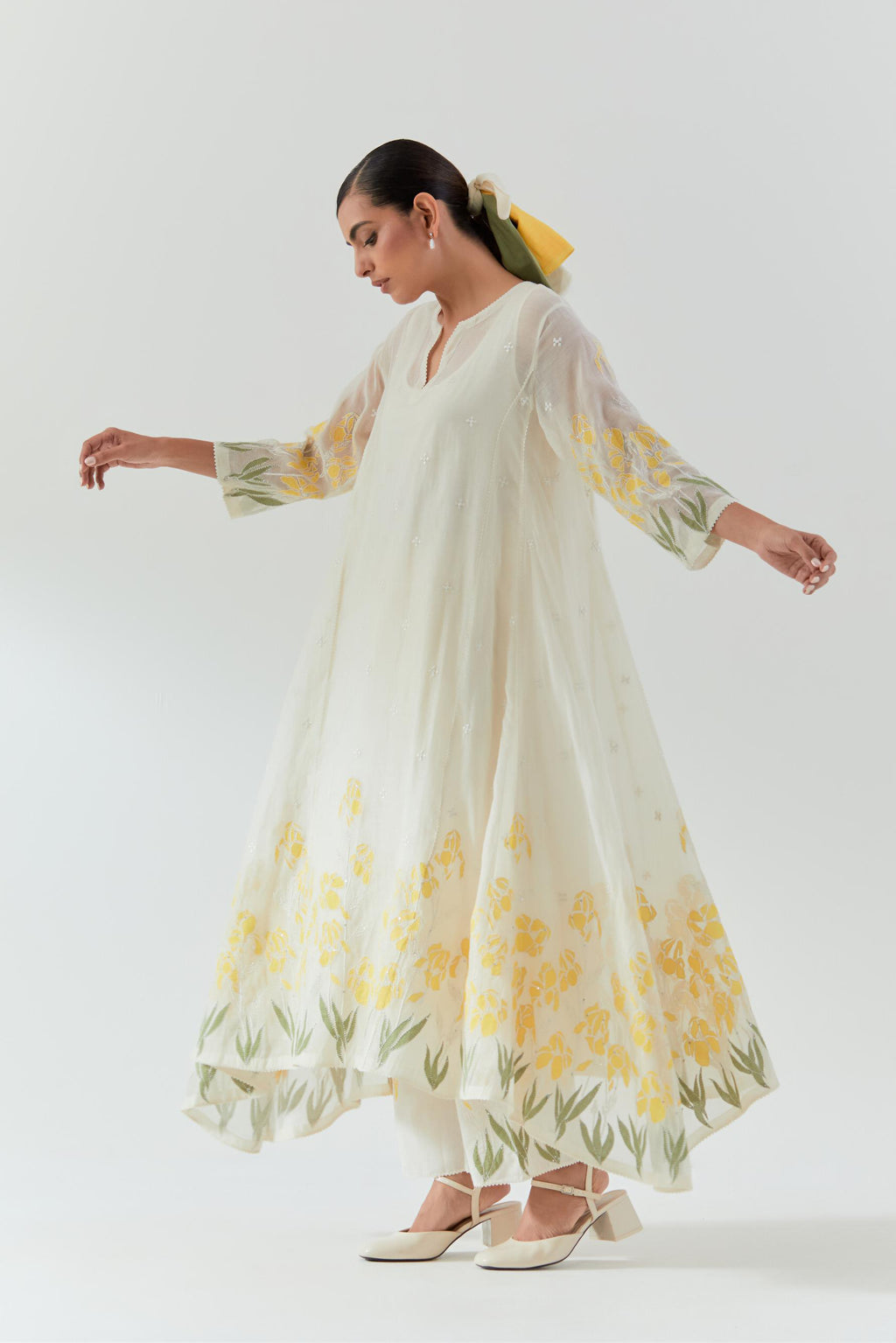Off white cotton chanderi easy fit, asymmetric hem, paneled kurta set with yellow & green applique work at hem and sleeves.