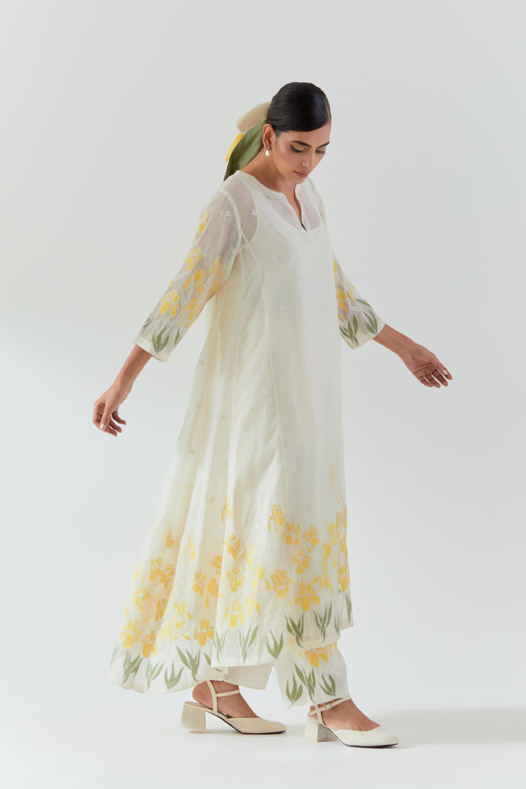 Off white cotton chanderi easy fit, asymmetric hem, paneled kurta set with yellow & green applique work at hem and sleeves.