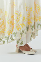 Off white cotton chanderi easy fit, asymmetric hem, paneled kurta set with yellow & green applique work at hem and sleeves.