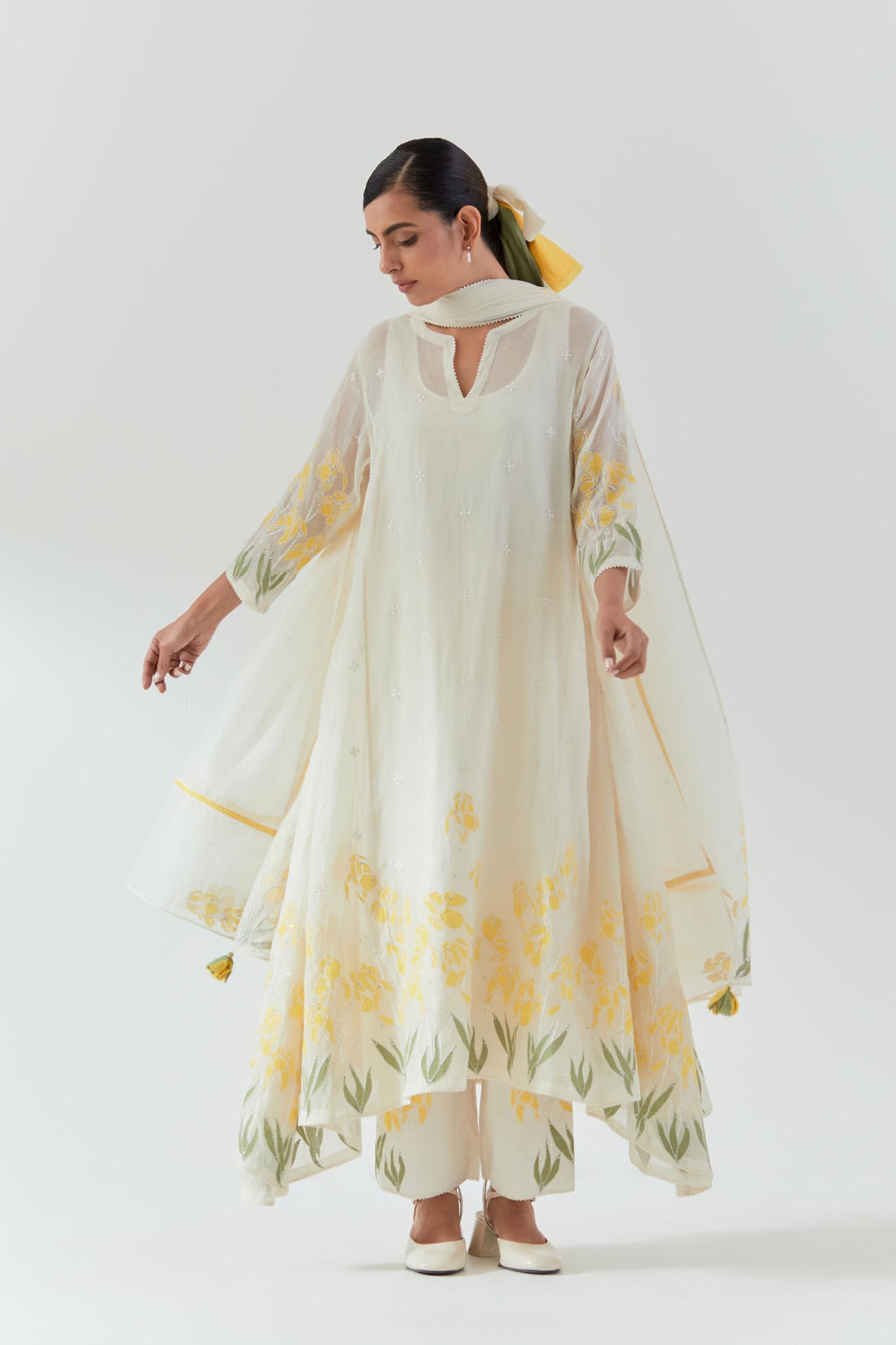 Off white cotton chanderi easy fit, asymmetric hem, paneled kurta set with yellow & green applique work at hem and sleeves.