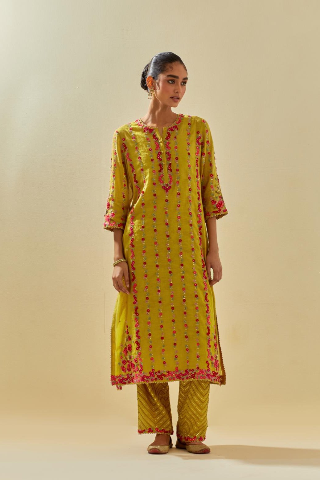 Yellow tissue chanderi paneled kurta set with front placket neckline and all-over hand cut silk flower embroidery.