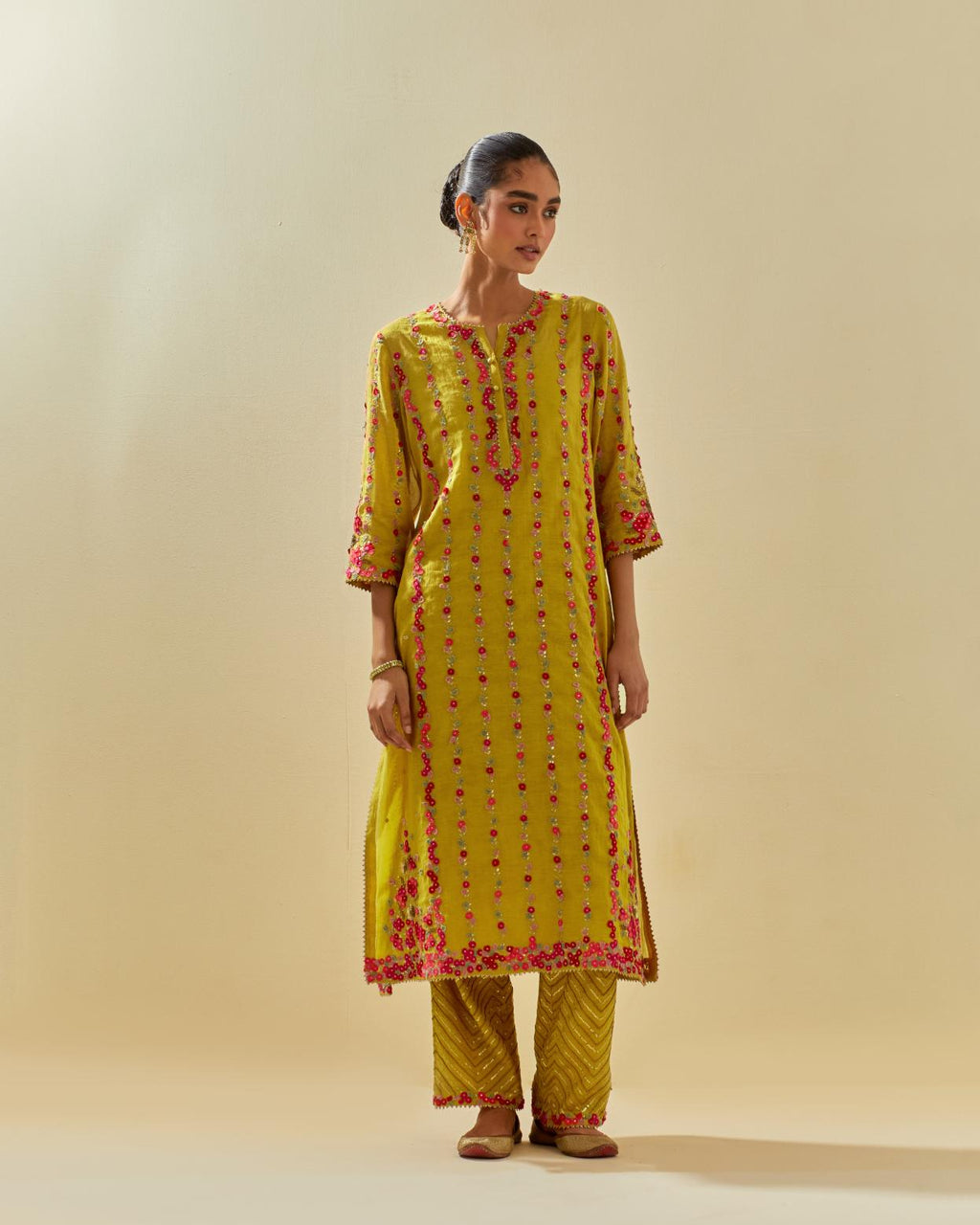 Yellow tissue chanderi paneled kurta set with front placket neckline and all-over hand cut silk flower embroidery.