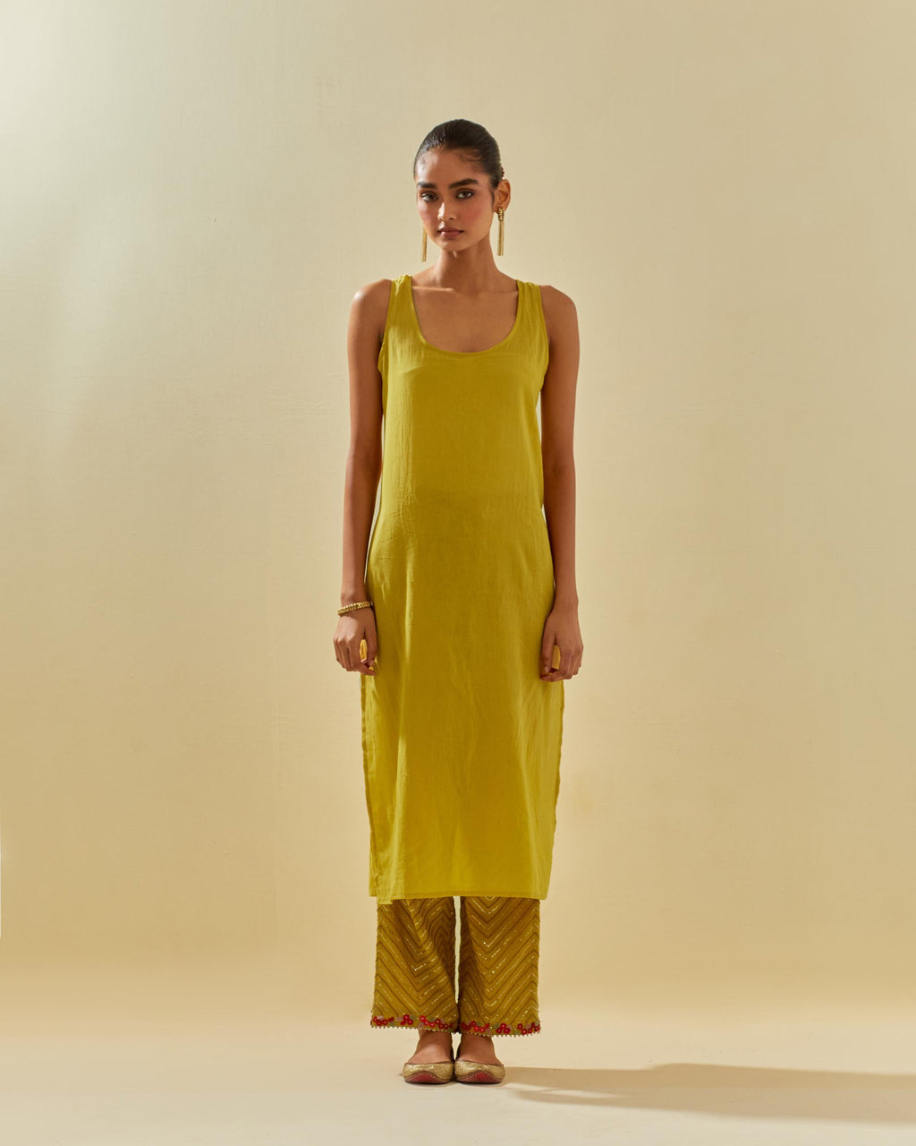 Yellow tissue chanderi straight kurta set, with contrast silk hand cut flowers embroidery, highlighted with gold sequins.