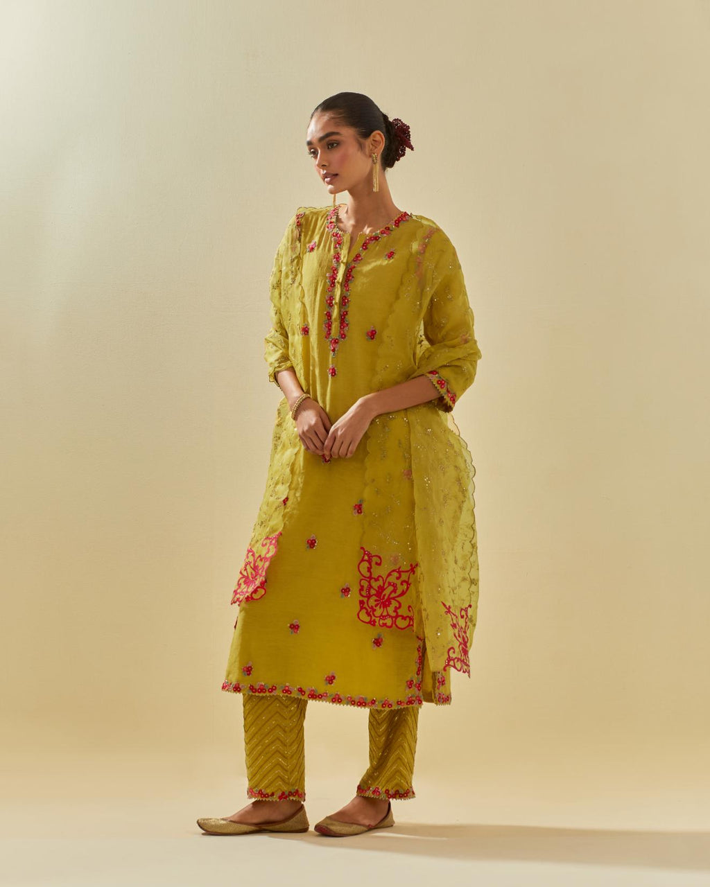 Yellow tissue chanderi straight kurta set, with contrast silk hand cut flowers embroidery, highlighted with gold sequins.