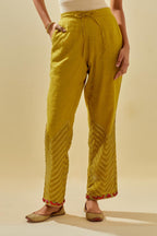 Yellow tissue chanderi straight pants with hand cut silk flower embroidery at hem, highlighted with gold sequins and beads.