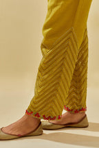 Yellow tissue chanderi straight pants with hand cut silk flower embroidery at hem, highlighted with gold sequins and beads.