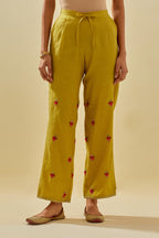 Yellow tissue chanderi straight pants with hand cut silk flower embroidered booti, highlighted with gold sequins.