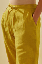 Yellow tissue chanderi straight pants with hand cut silk flower embroidered booti, highlighted with gold sequins.