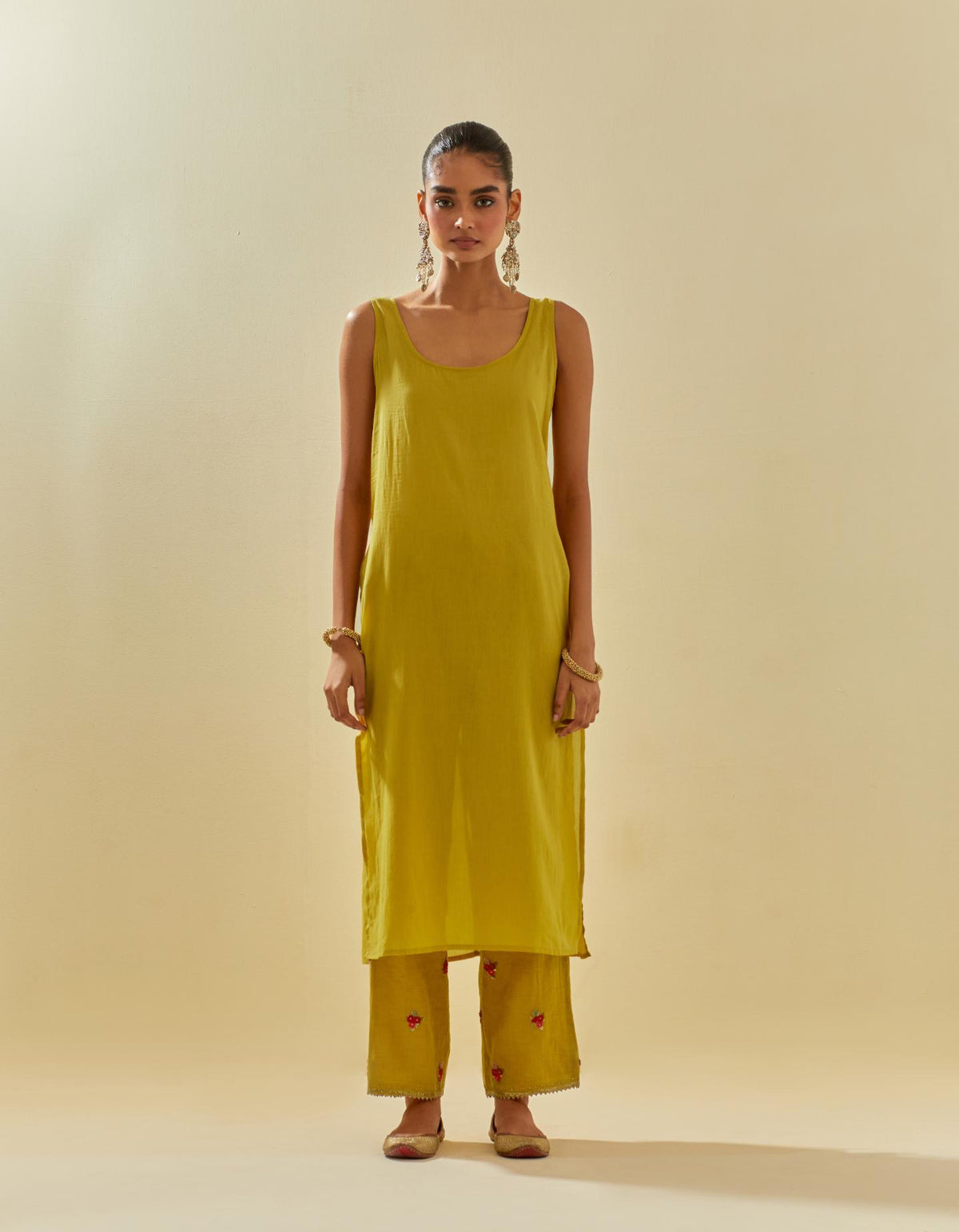 Yellow tissue chanderi straight kurta set with randomly placed hand cut silk flower bunches, highlighted with gold sequins.