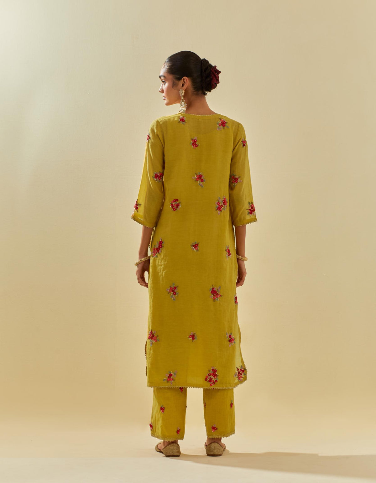 Yellow tissue chanderi straight kurta set with randomly placed hand cut silk flower bunches, highlighted with gold sequins.