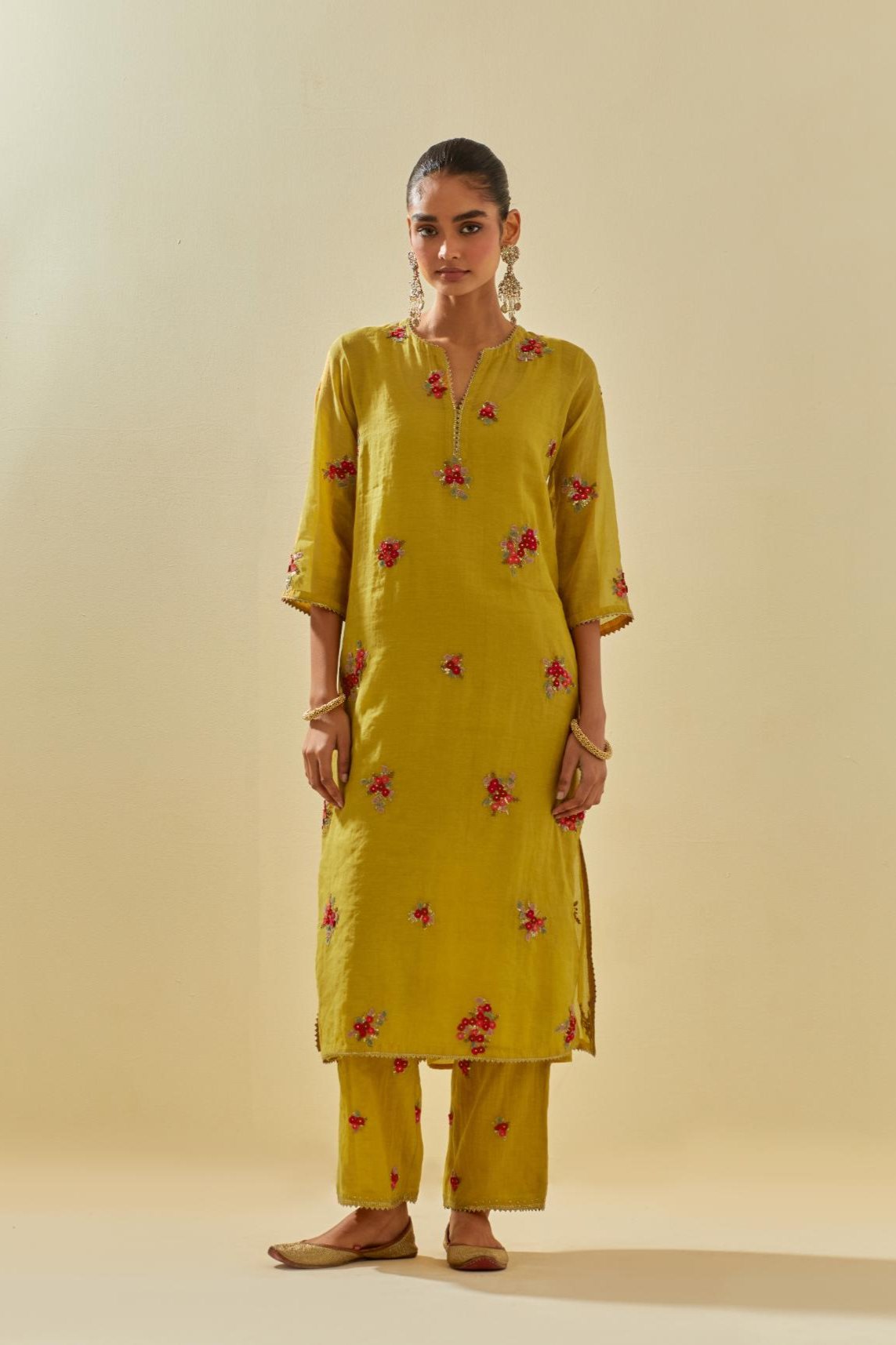 Yellow tissue chanderi straight kurta set with randomly placed hand cut silk flower bunches, highlighted with gold sequins.