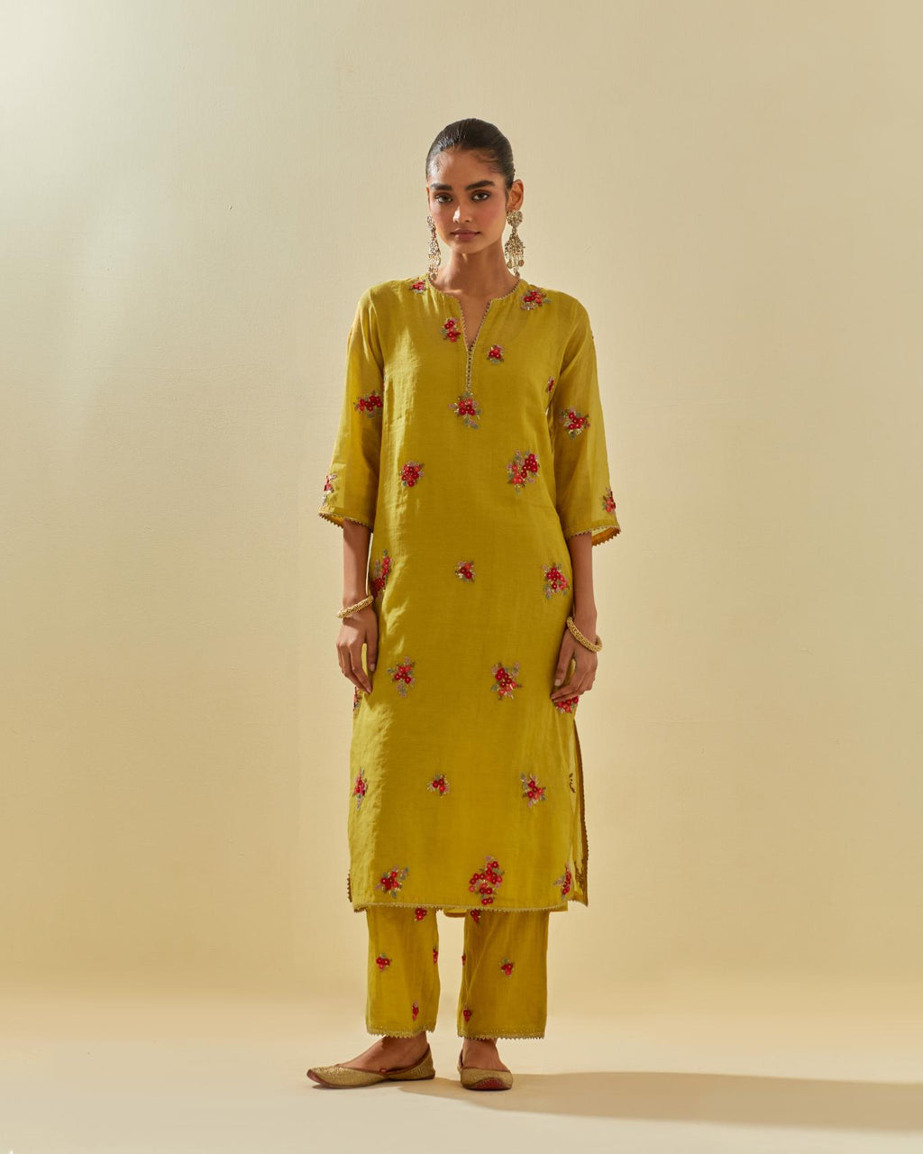 Yellow tissue chanderi straight kurta set with randomly placed hand cut silk flower bunches, highlighted with gold sequins.