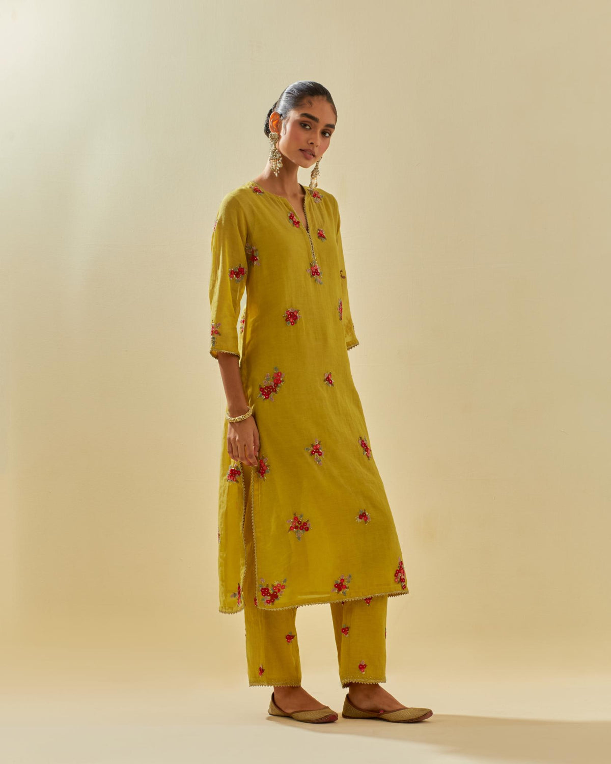 Yellow tissue chanderi straight kurta set with randomly placed hand cut silk flower bunches, highlighted with gold sequins.