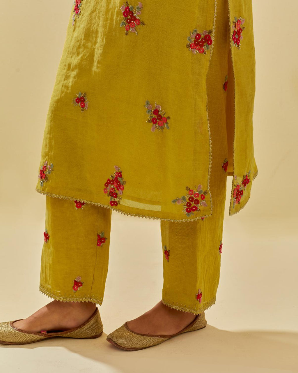 Yellow tissue chanderi straight kurta set with randomly placed hand cut silk flower bunches, highlighted with gold sequins.
