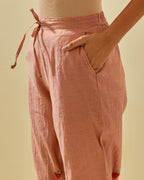 Pink tissue chanderi straight pants with hand cut silk flower embroidered booti, highlighted with gold sequins.