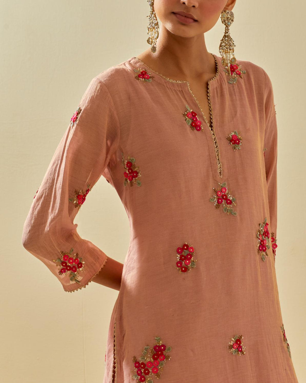 Pink tissue chanderi straight kurta set with randomly placed hand cut silk flower bunches, highlighted with gold sequins.