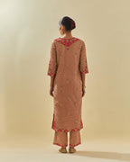 Pink tissue chanderi straight kurta set with delicate hand cut silk flower embroidery, highlighted with gold sequins and beads.