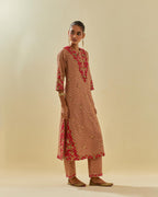 Pink tissue chanderi straight kurta set with delicate hand cut silk flower embroidery, highlighted with gold sequins and beads.