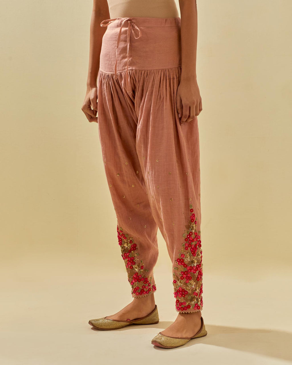 Pink tissue chanderi salwar with hand cut silk flower embroidery, highlighted with gold sequins.