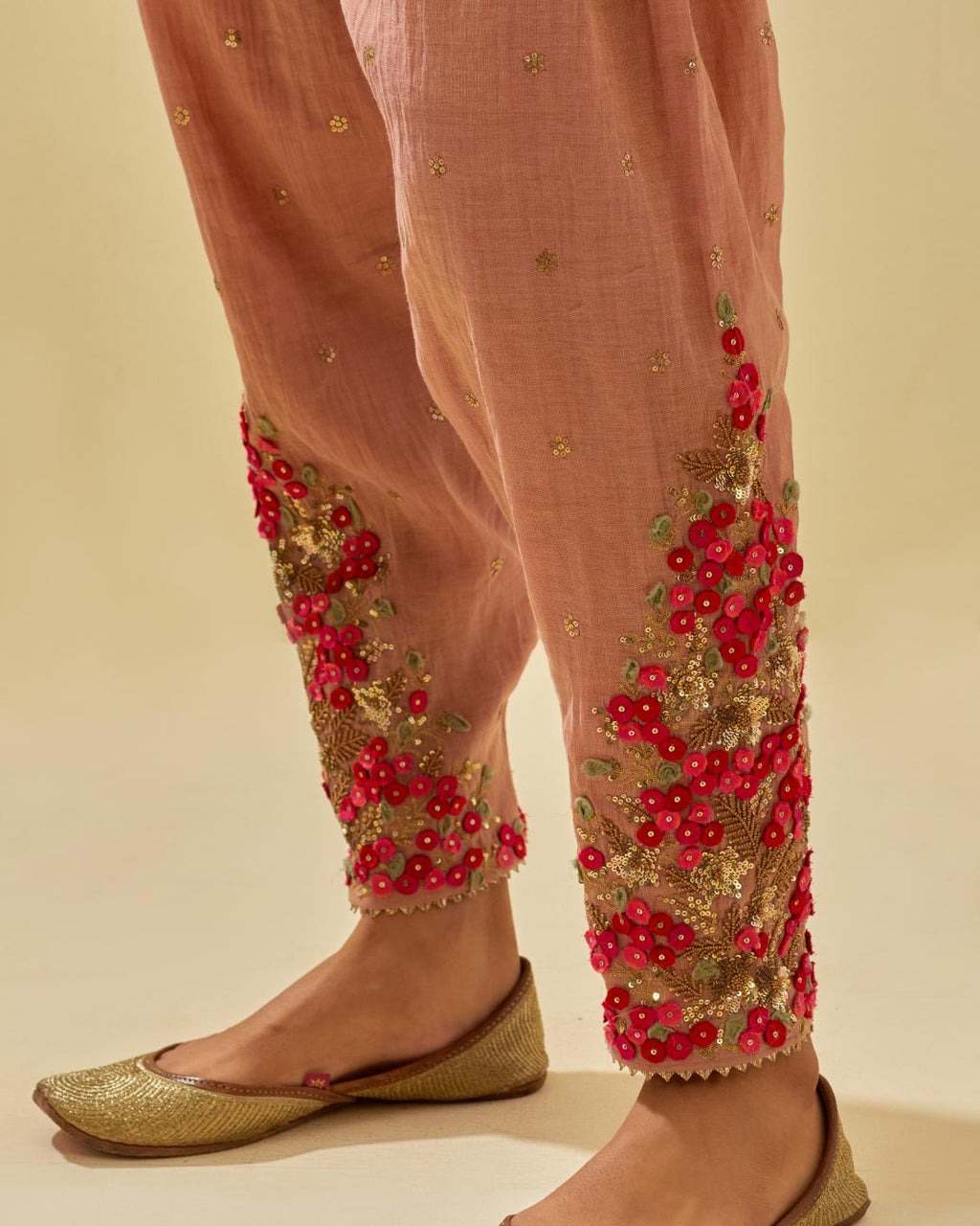Pink tissue chanderi salwar with hand cut silk flower embroidery, highlighted with gold sequins.