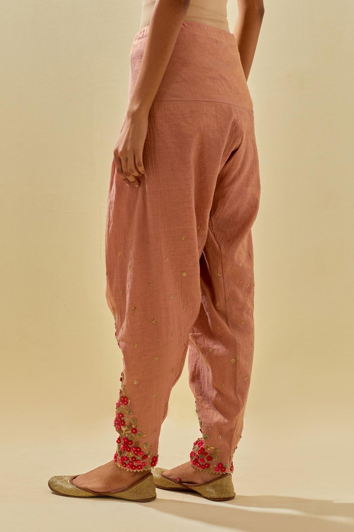 Pink tissue chanderi salwar with hand cut silk flower embroidery, highlighted with gold sequins.