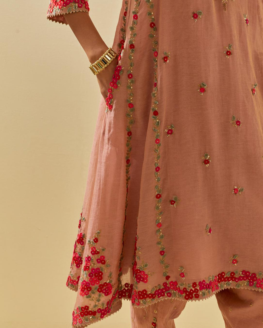 Pink tissue chanderi mid length kalidar kurta set with hand cut silk flower embroidery, highlighted with gold sequins.