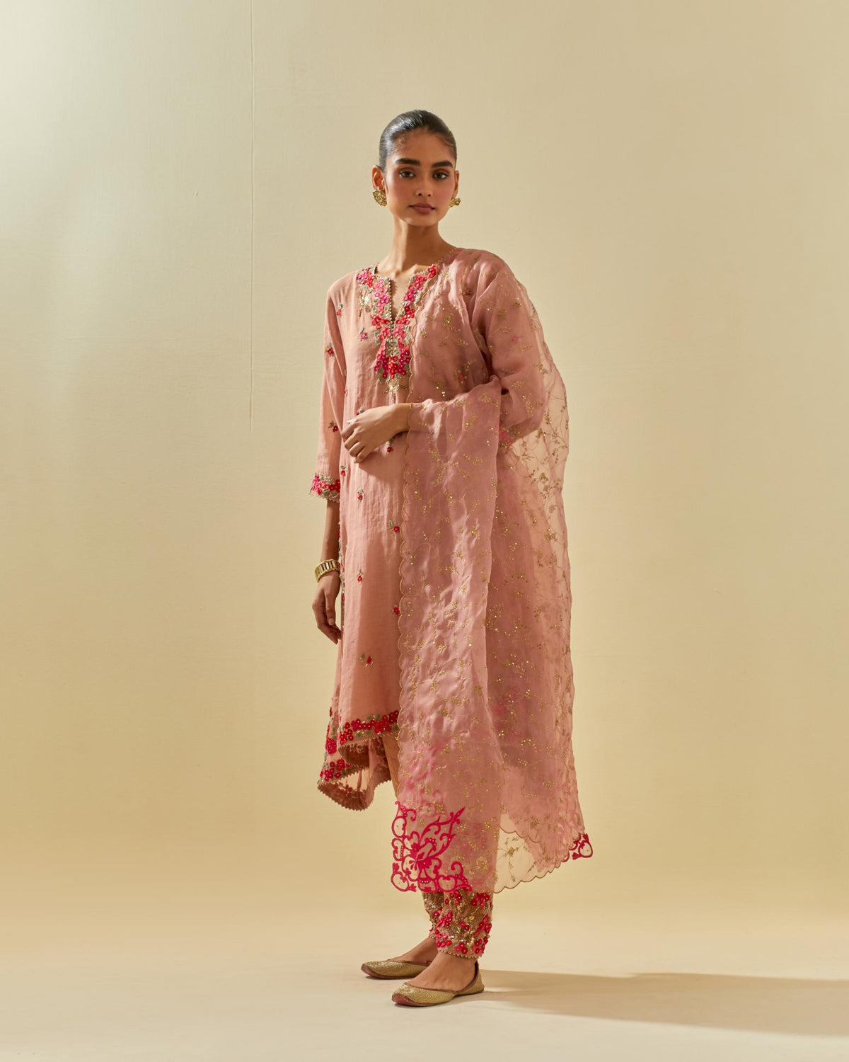Pink tissue chanderi mid length kalidar kurta set with hand cut silk flower embroidery, highlighted with gold sequins.