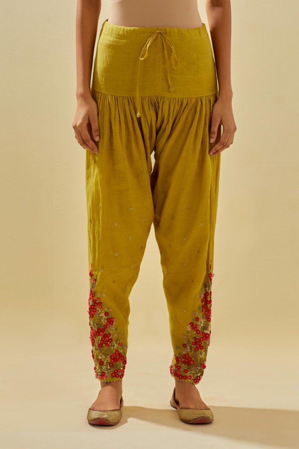 Yellow tissue chanderi salwar with hand cut silk flower embroidery, highlighted with gold sequins.
