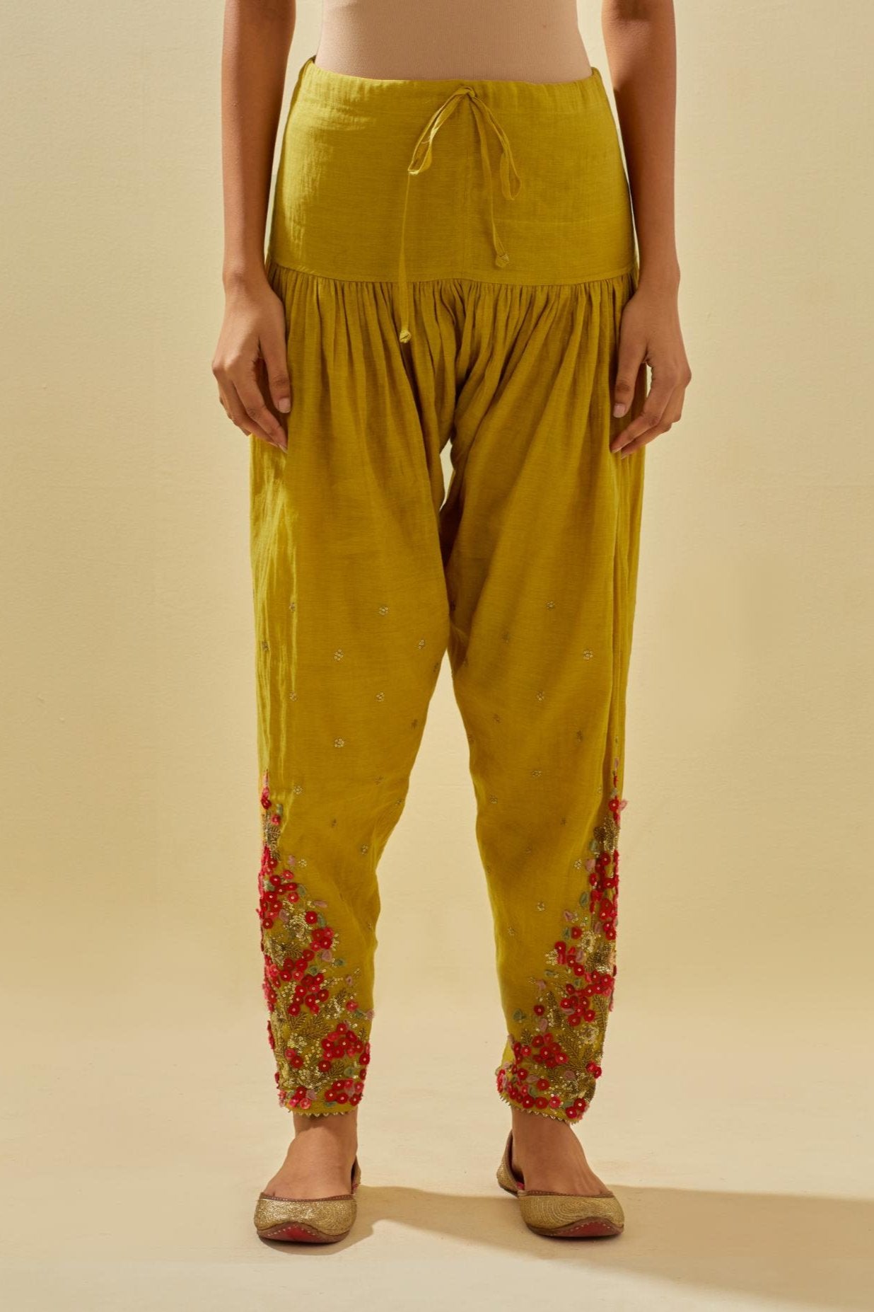 Yellow tissue chanderi salwar with hand cut silk flower embroidery, highlighted with gold sequins.