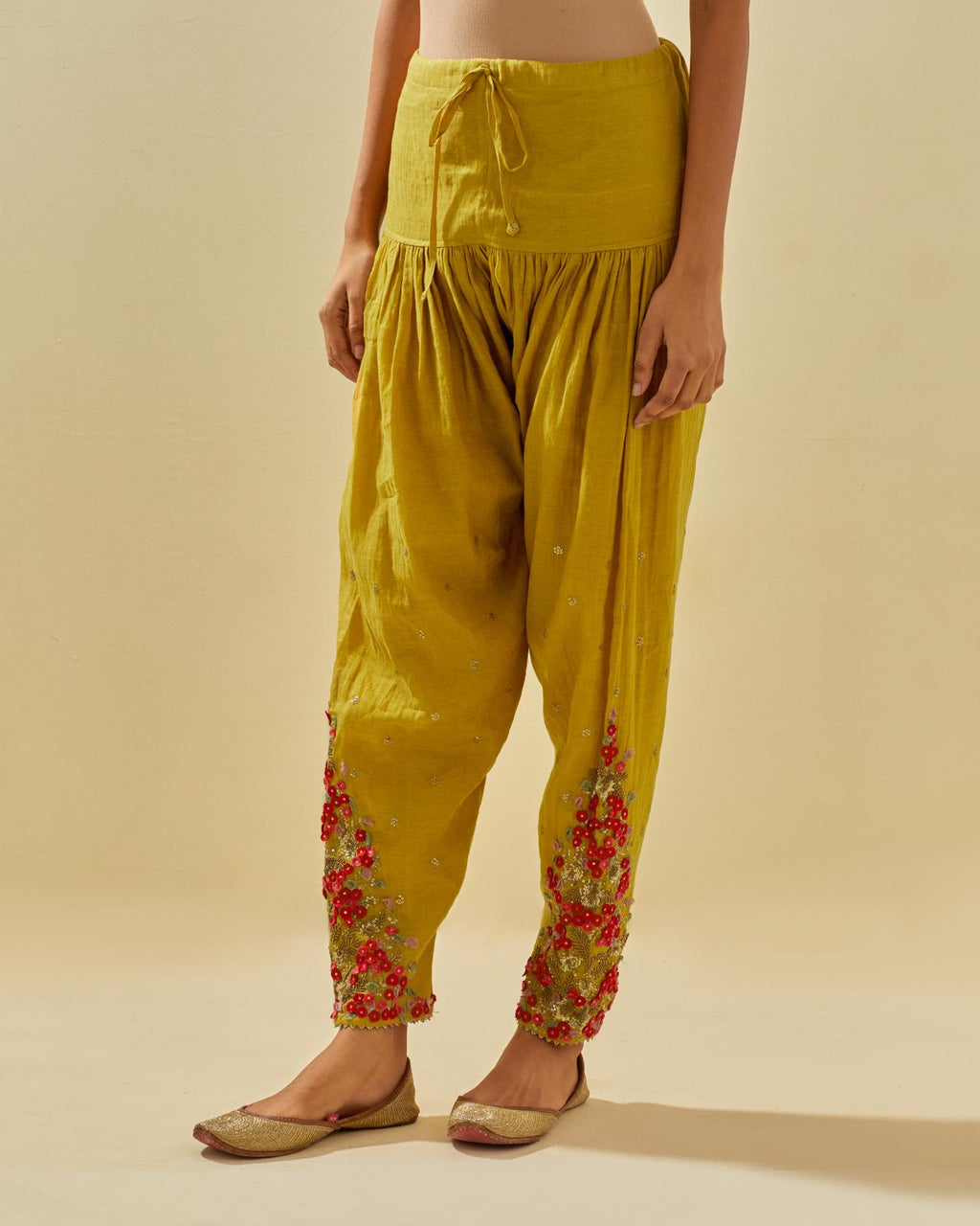 Yellow tissue chanderi salwar with hand cut silk flower embroidery, highlighted with gold sequins.