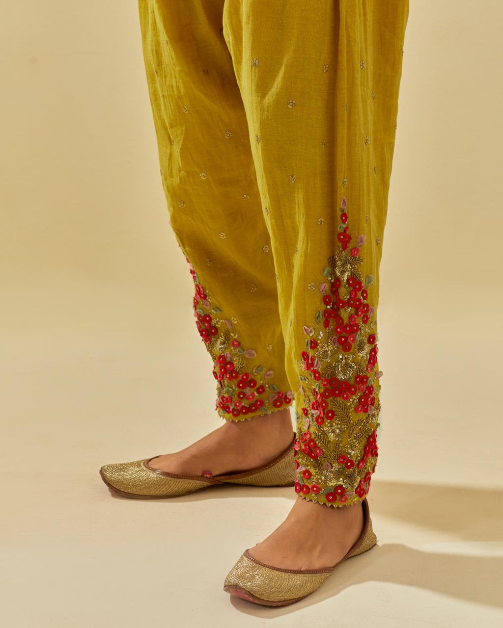 Yellow tissue chanderi salwar with hand cut silk flower embroidery, highlighted with gold sequins.