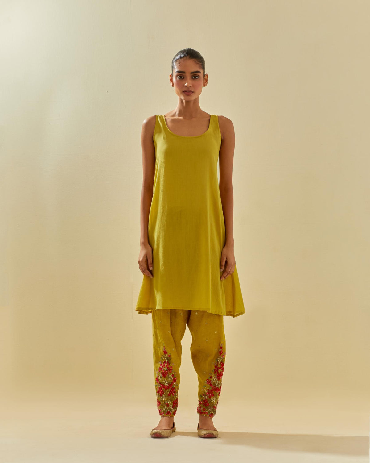 Yellow tissue chanderi mid length kalidar kurta set with hand cut silk flower embroidery, highlighted with gold sequins.