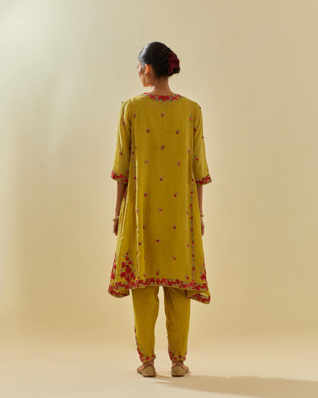 Yellow tissue chanderi mid length kalidar kurta set with hand cut silk flower embroidery, highlighted with gold sequins.