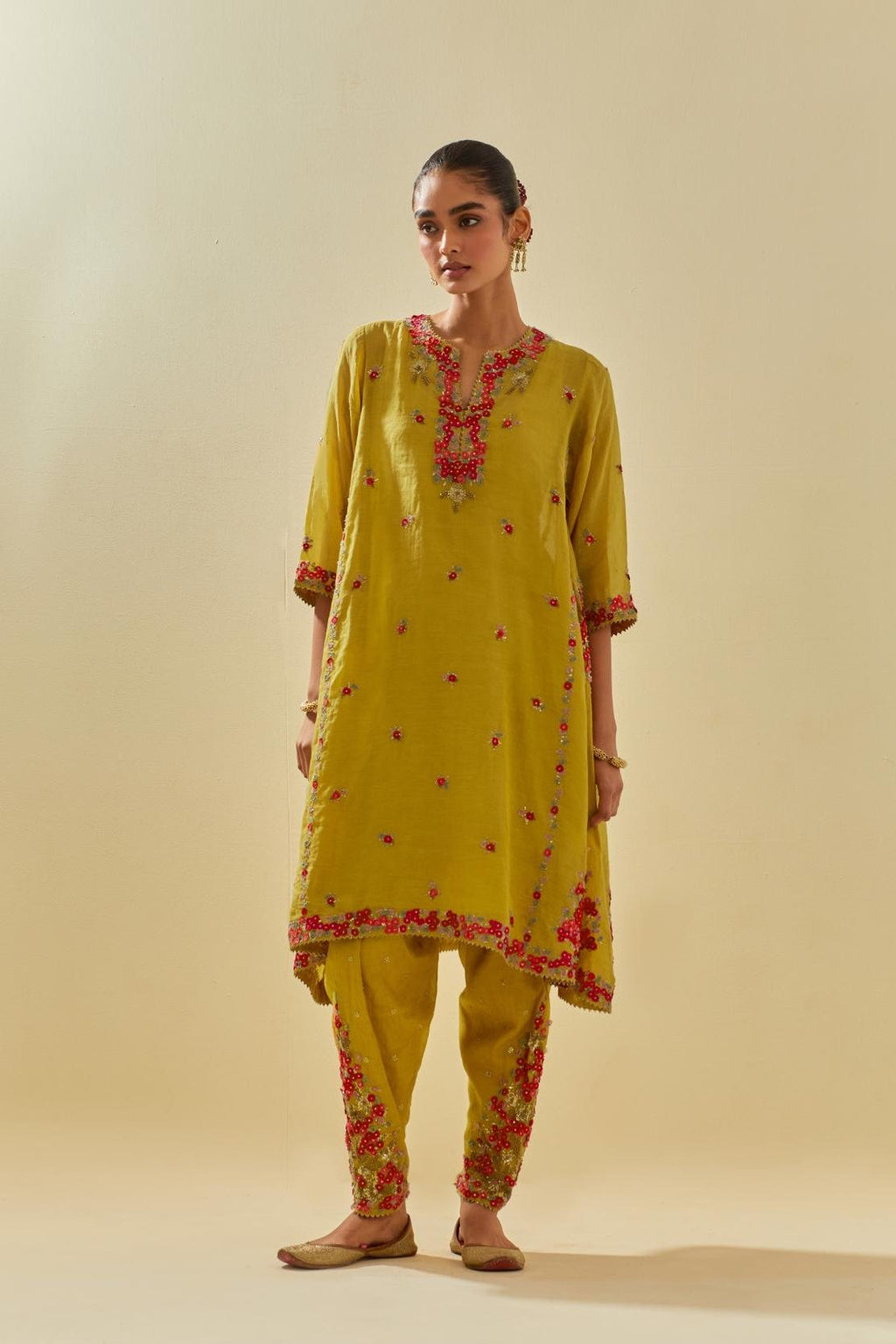 Yellow tissue chanderi mid length kalidar kurta set with hand cut silk flower embroidery, highlighted with gold sequins.