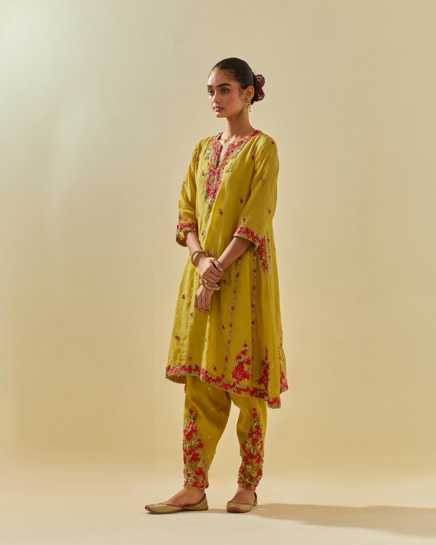 Yellow tissue chanderi mid length kalidar kurta set with hand cut silk flower embroidery, highlighted with gold sequins.