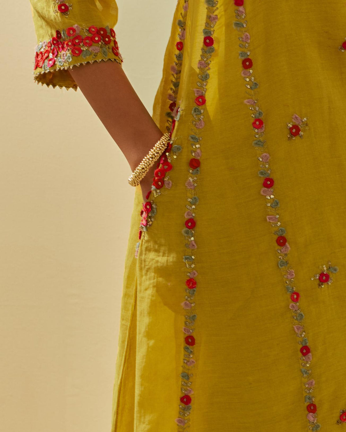 Yellow tissue chanderi mid length kalidar kurta set with hand cut silk flower embroidery, highlighted with gold sequins.