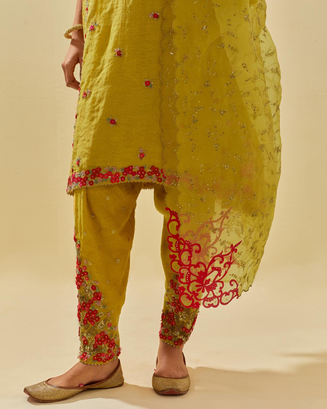 Yellow tissue chanderi mid length kalidar kurta set with hand cut silk flower embroidery, highlighted with gold sequins.
