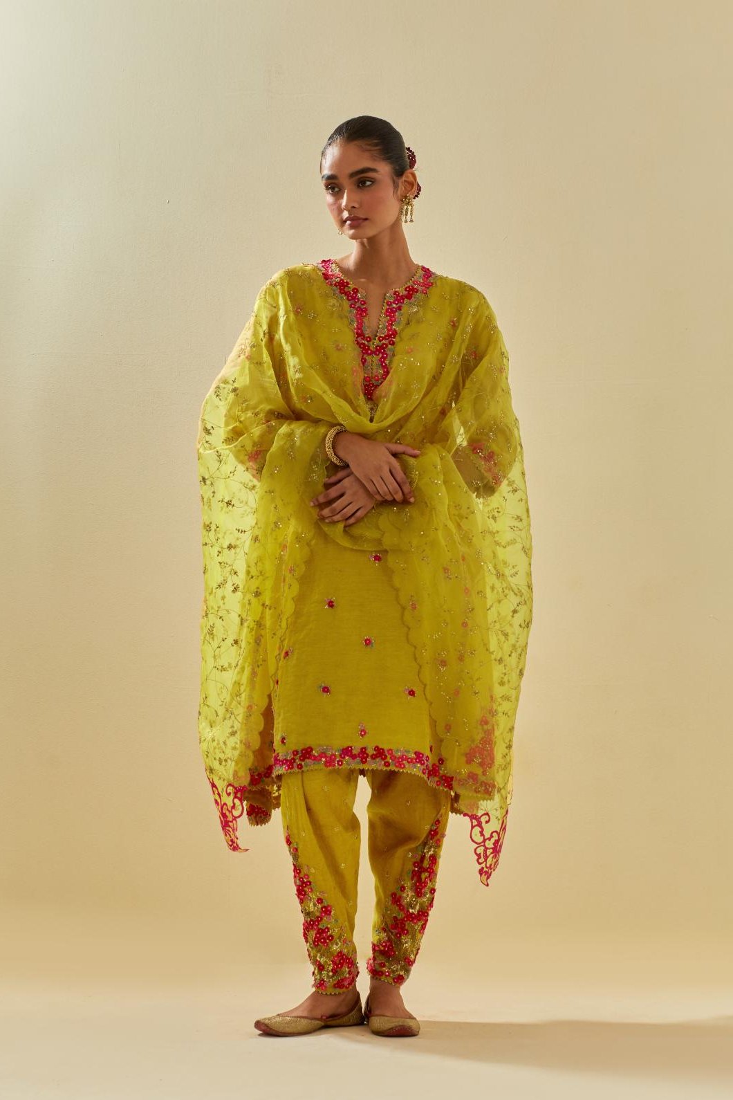 Yellow tissue chanderi mid length kalidar kurta set with hand cut silk flower embroidery, highlighted with gold sequins.